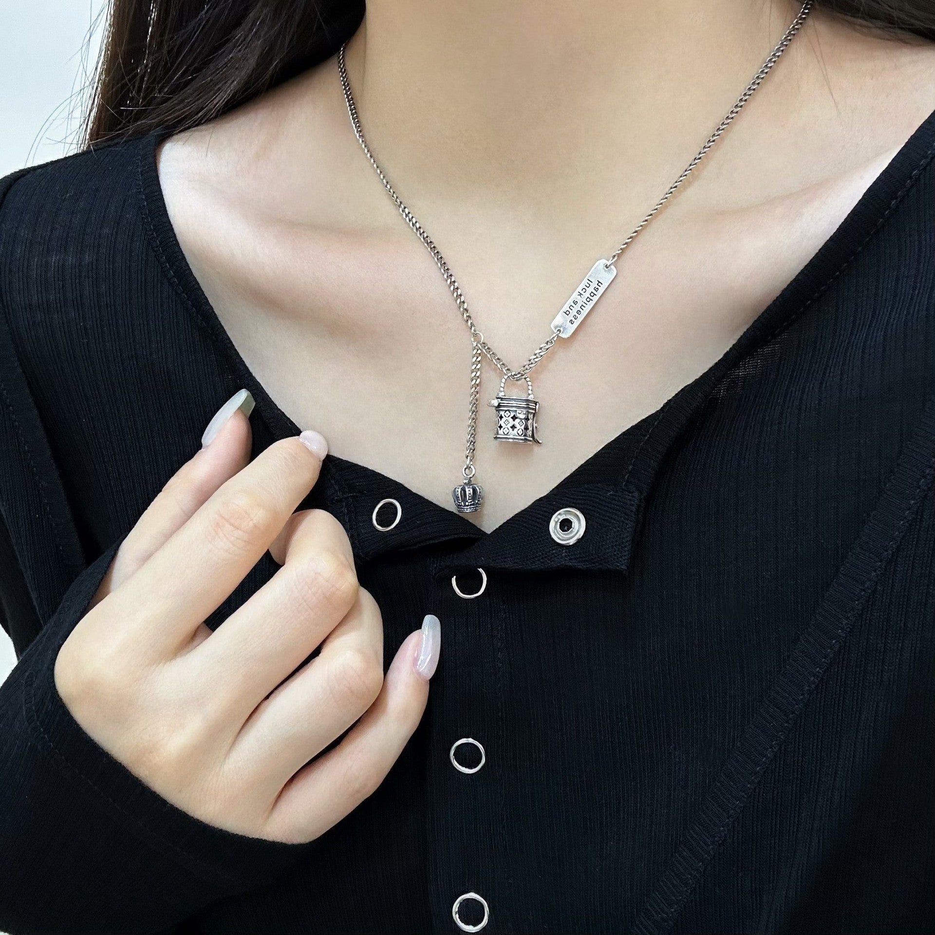 The S925 sterling silver monogram bucket bag necklace can be unlocked, with a pendant, hollow crown, niche design, and a light luxury and high-end necklace