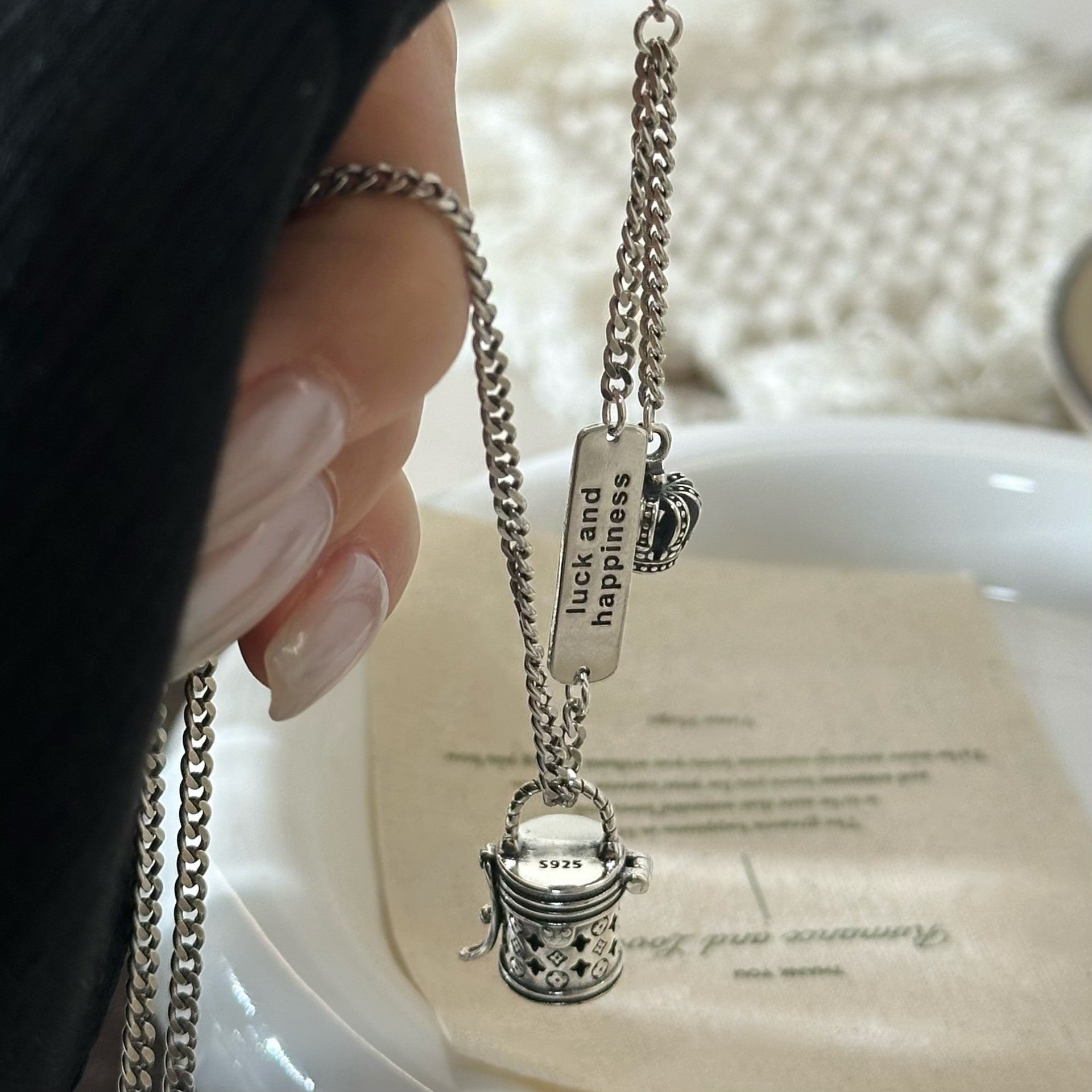 The S925 sterling silver monogram bucket bag necklace can be unlocked, with a pendant, hollow crown, niche design, and a light luxury and high-end necklace